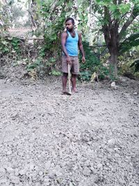 Full length of teenage girl standing in forest