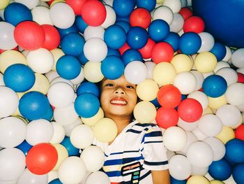 Portrait of smiling boy at balloons