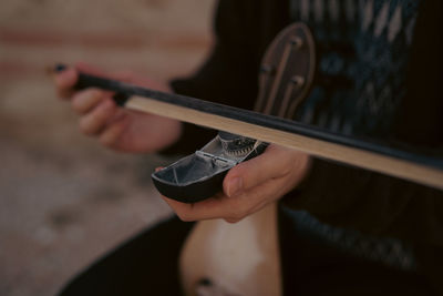 Cropped hand of man using mobile phone