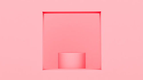 Close-up of pink art on red wall