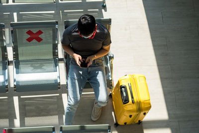 High angle view of man sitting at airport