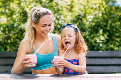 Portrait of a smiling girl sitting outdoors