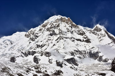 Snow covered mountains against sky