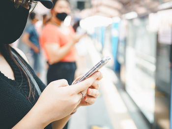 Midsection of woman using mobile phone