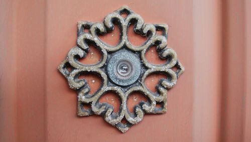 Close-up of peephole on wooden door