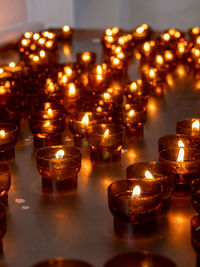 Lit tea light candles in temple