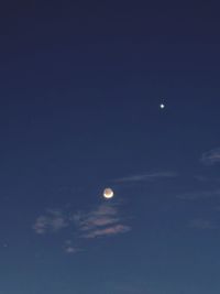 Low angle view of moon in sky at night