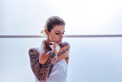 Confident young woman with tattoo