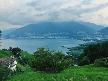 Scenic view of townscape by mountains against sky