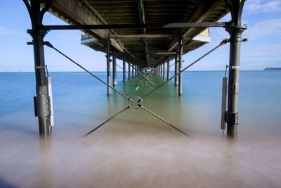 Pier over sea against sky