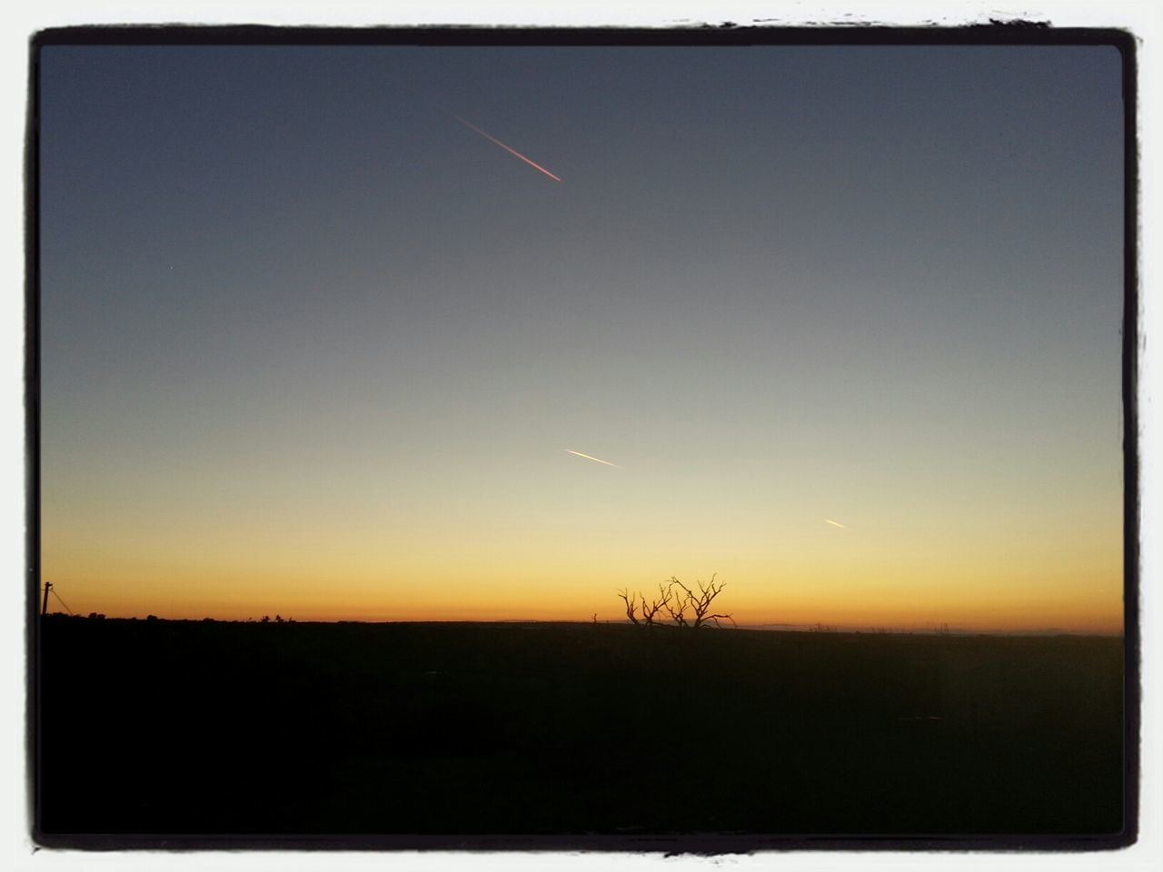 sunset, silhouette, tranquil scene, landscape, scenics, tranquility, copy space, beauty in nature, clear sky, nature, orange color, field, idyllic, sky, horizon over land, transfer print, dusk, auto post production filter, outdoors, non-urban scene