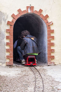 Rear view of boy with red umbrella