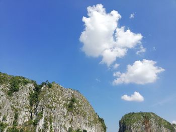 Low angle view of mountain against blue sky