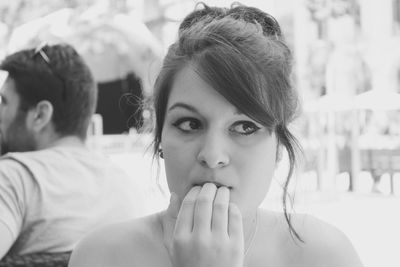 Thoughtful young woman nail biting