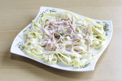 High angle view of chopped vegetables in plate on table