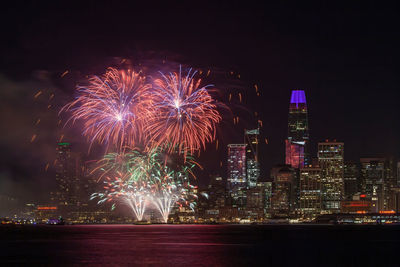 Low angle view of firework display at night