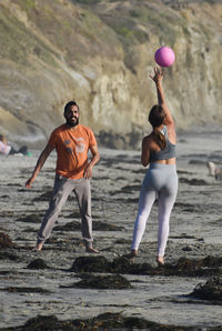 Rear view of men on beach
