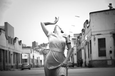 Woman standing on city street