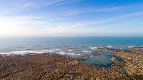 Scenic view of sea against blue sky