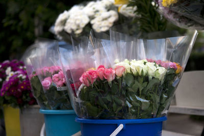 Close-up of flower bouquets in buckets at market stall