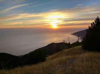 Scenic view of landscape against sky at sunset