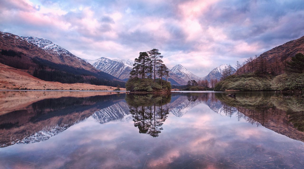 reflection, water, lake, sky, tranquil scene, tranquility, mountain, cloud - sky, scenics, beauty in nature, standing water, nature, symmetry, cloud, mountain range, cloudy, season, idyllic, majestic, weather, calm, outdoors, day, non-urban scene, no people, travel destinations, tourism, landscape