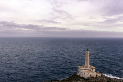 High angle view of lighthouse by sea against sky