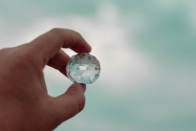 Close-up of human hand holding sphere