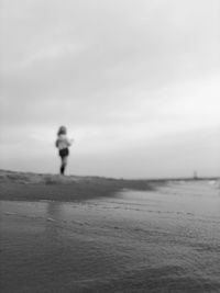 Man on beach against sky