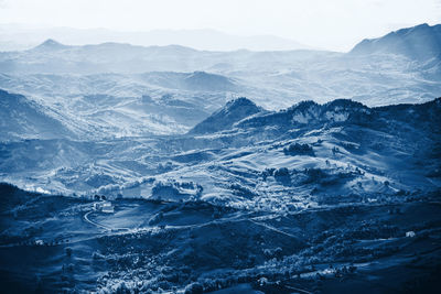 High angle view of snowcapped mountains against sky