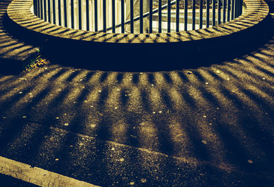 High angle view of shadow on railing