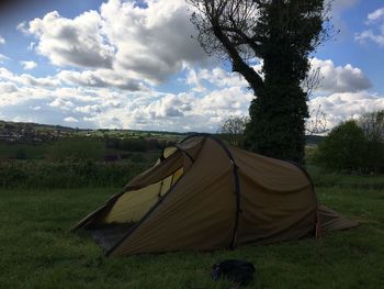 Tent on field against sky