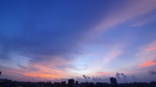 Scenic view of buildings against sky during sunset