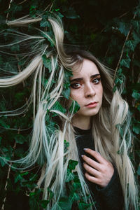 Portrait of beautiful young woman in forest