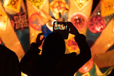 Midsection of woman photographing with mobile phone