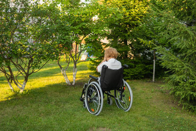 Side view of man riding bicycle on field