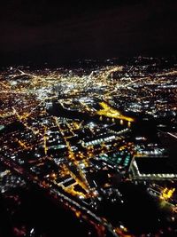 High angle view of illuminated buildings in city at night