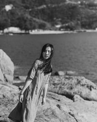 Portrait of woman standing on beach