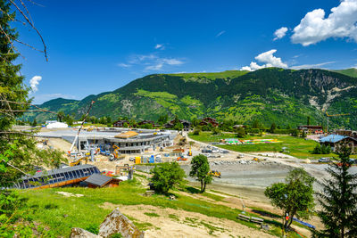 Scenic view of buildings and mountains against sky