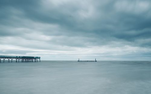 Pier over sea against sky