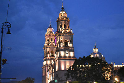 Low angle view of illuminated building against sky