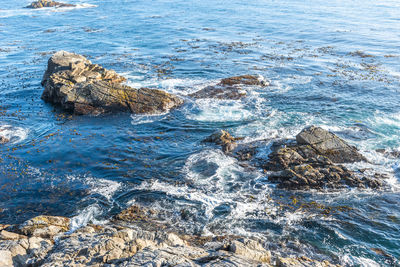 High angle view of rocks in sea