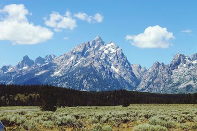 Scenic view of mountains against cloudy sky