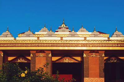 Low angle view of temple against clear blue sky