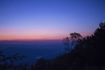 Scenic view of silhouette mountains against sky at sunset