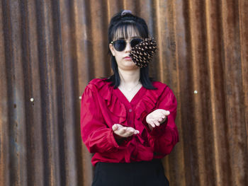 Young woman playing pine cone