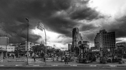Modern buildings against cloudy sky