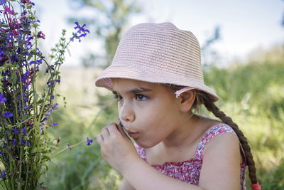 Portrait of girl looking at camera on field