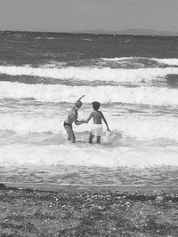 Boy standing on shore