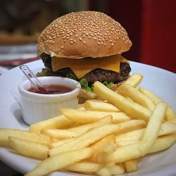 Close-up of burger and fries in plate